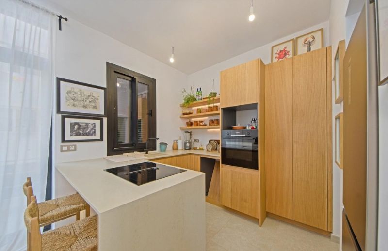 Custom oak timber kitchen with island bar and LED shelves in Palma