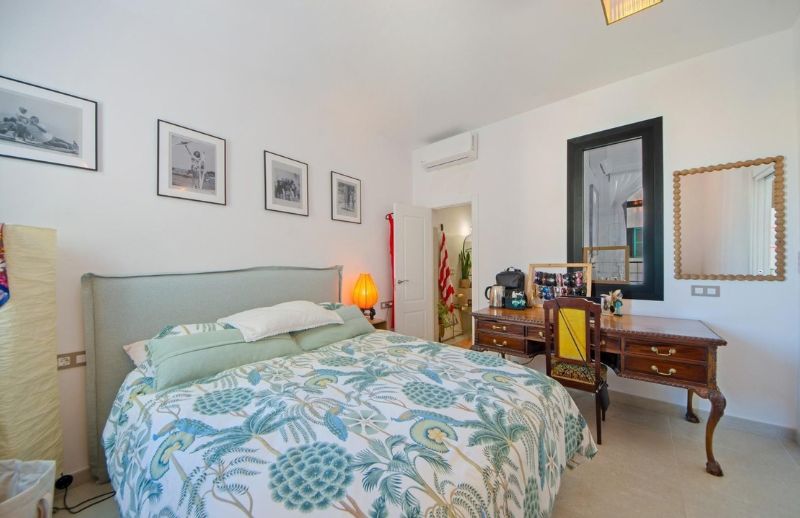 Contemporary Mediterranean bedroom with upholstered headboard in Palma Mallorca.