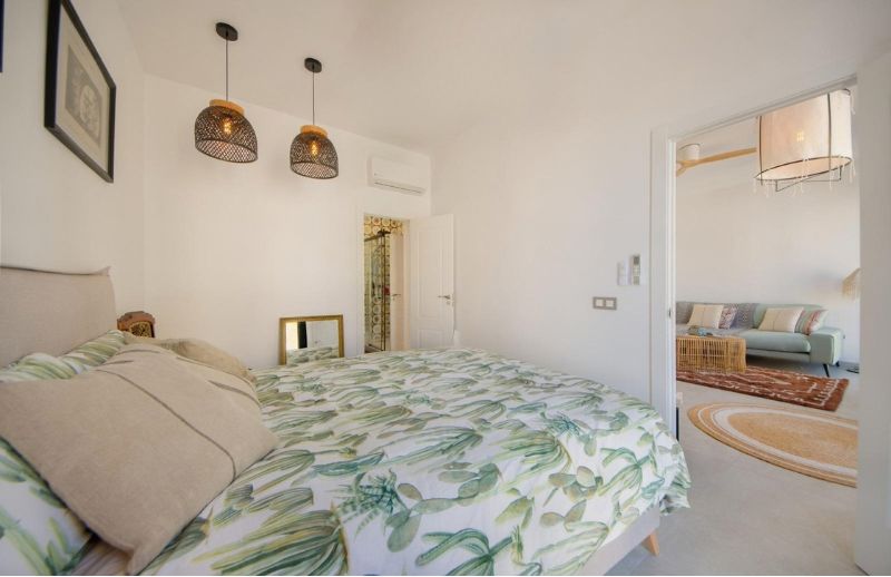 Refurbished double bedroom with rattan pendant lights and AC in Palma Mallorca